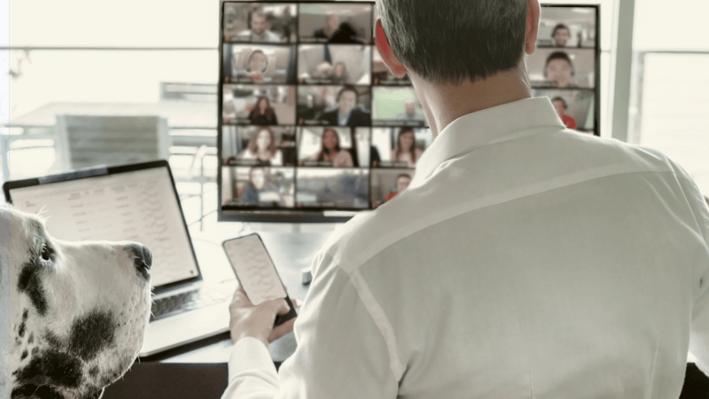 Leader sitting at desk meeting with team virtually