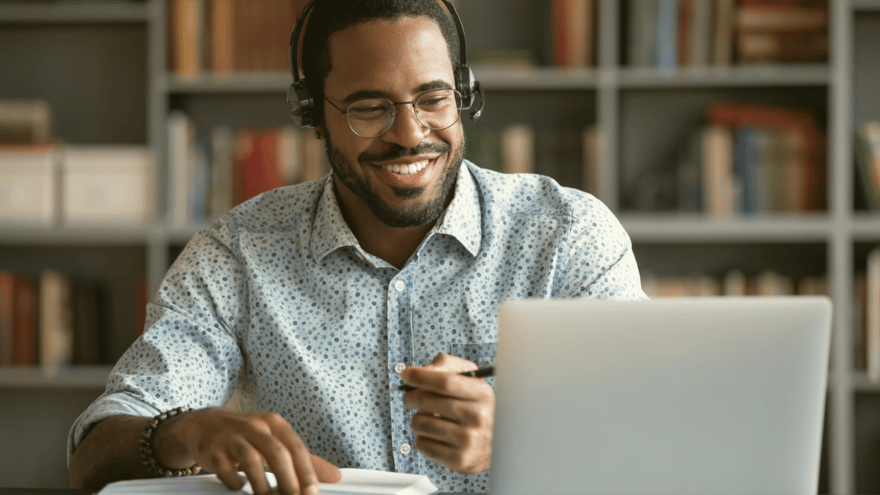 Man working at home on his laptop, enjoying learning virtually.